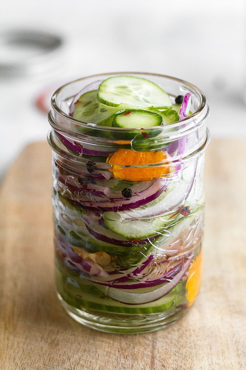 Spicy Sweet Pickled Cucumbers – Quick and easy pickled cucumbers with red onion and turmeric. Only takes a few minutes to make!