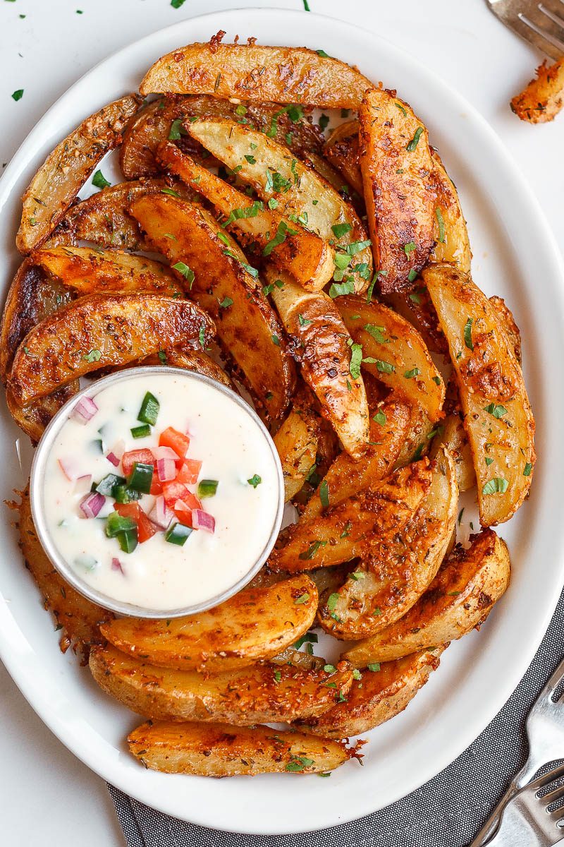 Baked Garlic Parmesan Potato Wedges - Crispy on the outside and tender on the inside, they will blow you away with their simplicity and fantastic flavor!