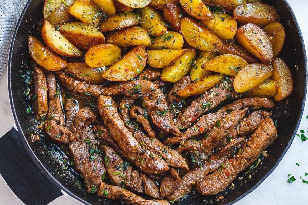 Garlic Butter Steak and Potatoes Skillet - This easy one-pan recipe is SO simple, and SO flavorful. The best steak and potatoes you'll ever have!