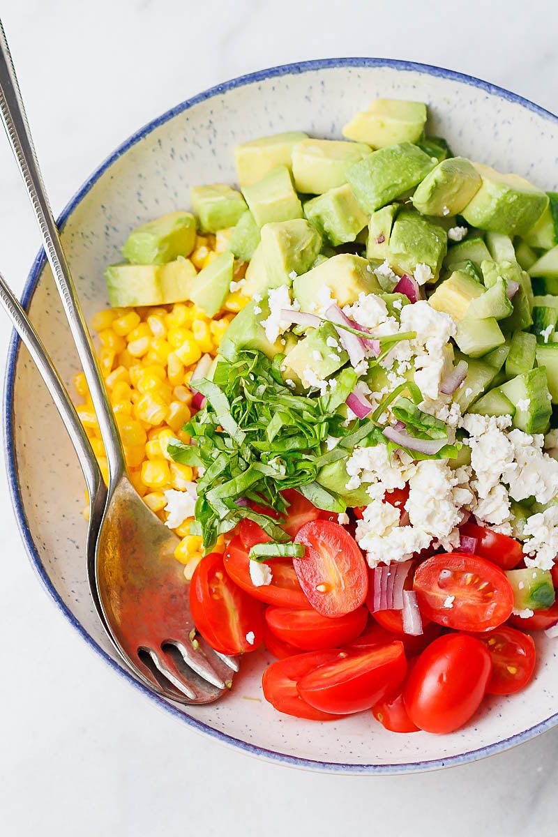 Avocado Feta Corn Salad Recipe - So much creaminess and flavor! This avocado corn salad is a light, yet satisfying meal.