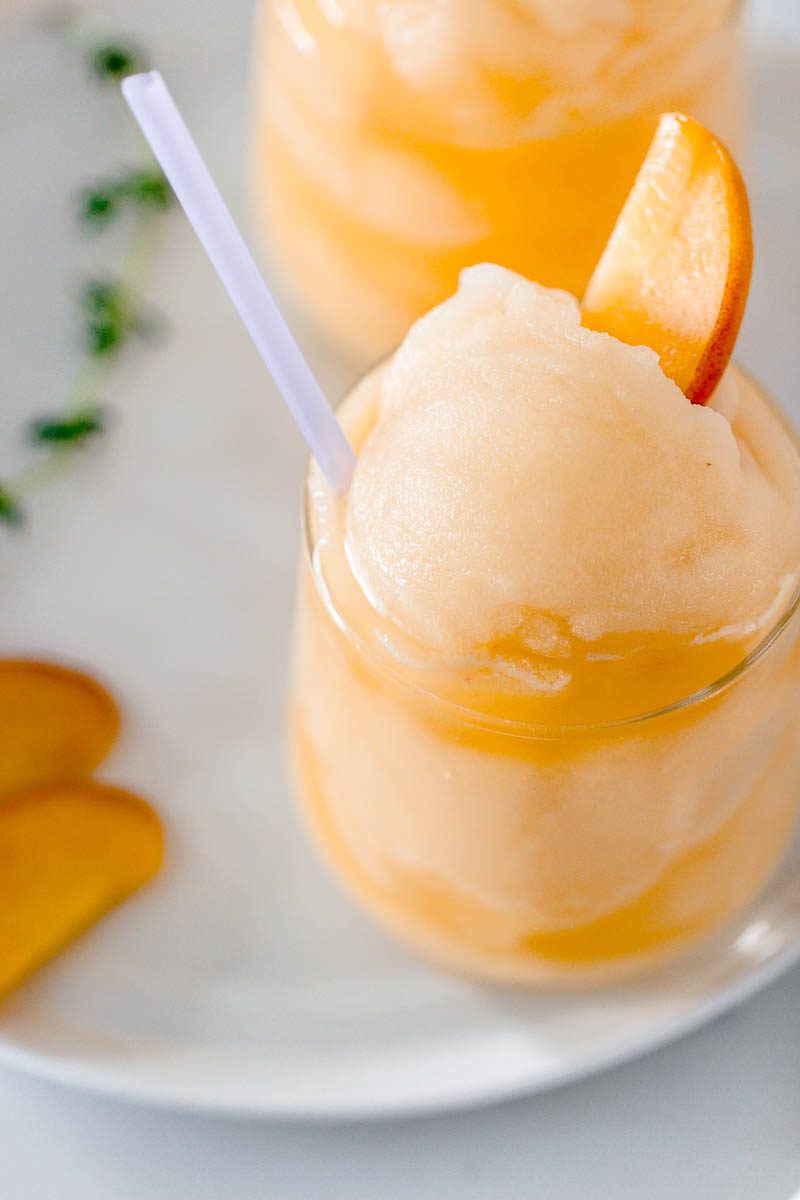 Frozen Peach Bellini Cocktail - Light, refreshing and super easy to make! This elegant cocktail slush will be a hit for any summer party.