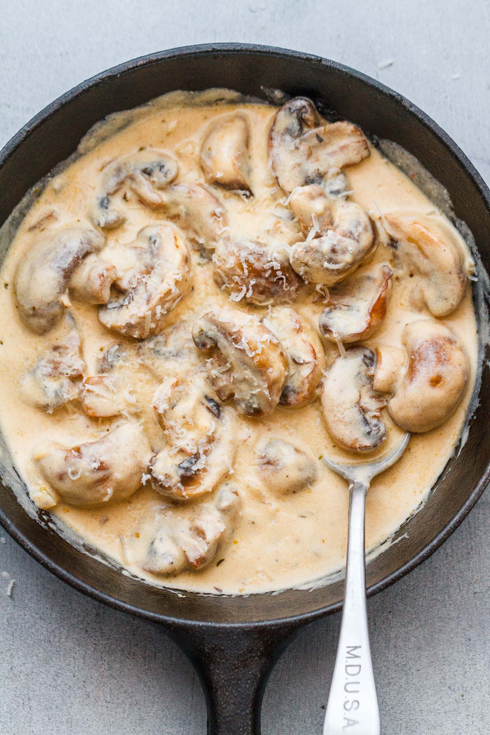 Creamy Garlic Parmesan Mushrooms with Bacon - A decadent garlic parmesan mushroom cream sauce that will have you licking your plate clean!