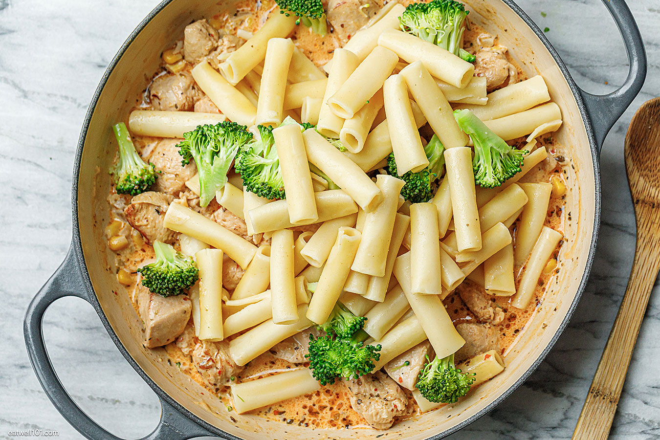 adding pasta to the creamy sauce